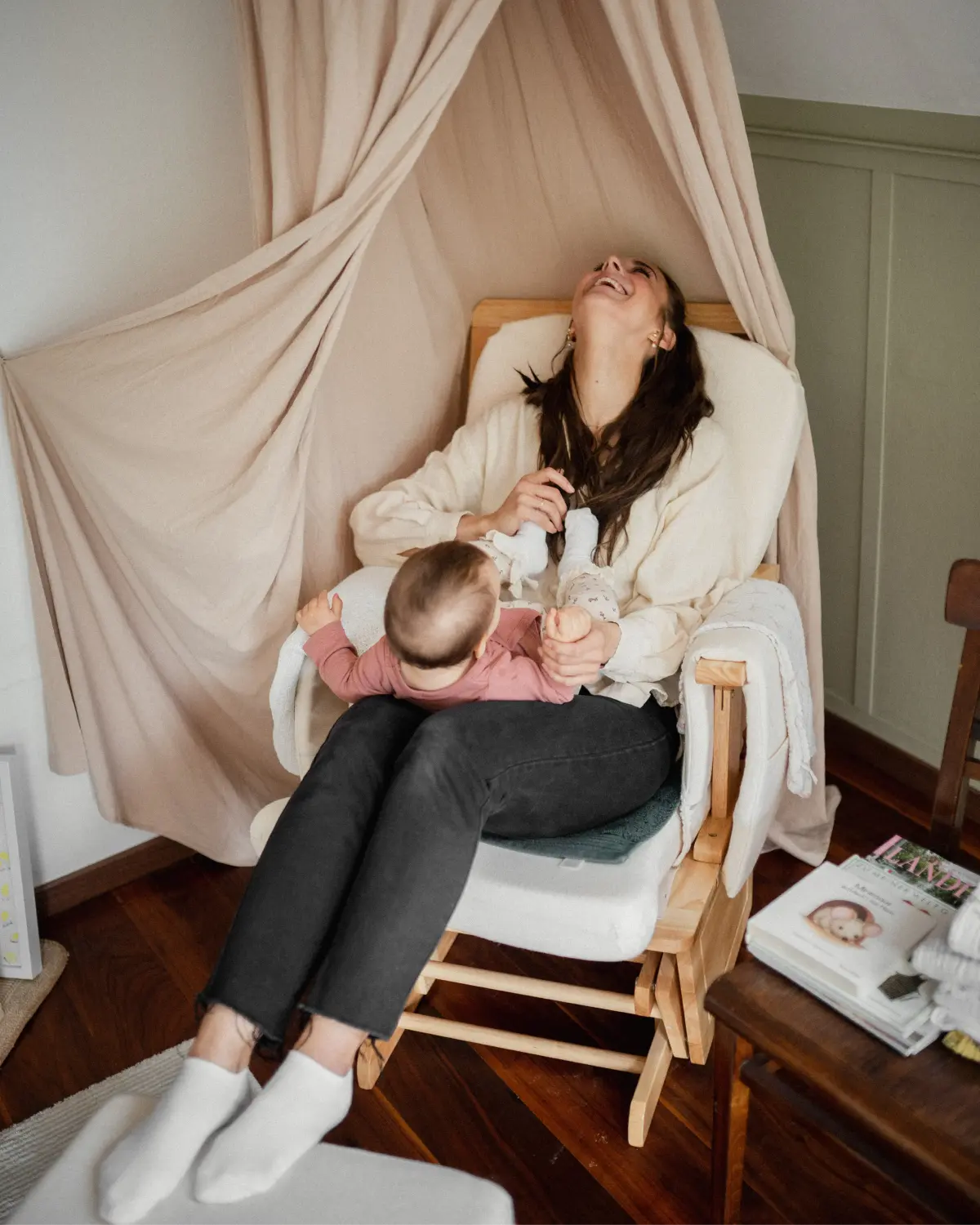 Flanny with Baby in chair laughing 